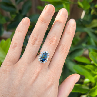Oval Blue Parti Sapphire Ring with Diamond Halo in Platinum and Yellow Gold by World Treasure Designs
