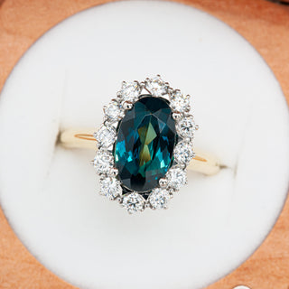 Oval Blue Parti Sapphire and Diamond Ring with Halo in Platinum and Yellow Gold by World Treasure Designs