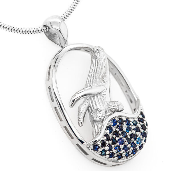 Humpback Whale Jumping out of Blue Sapphires in Sterling Silver by World Treasure Designs