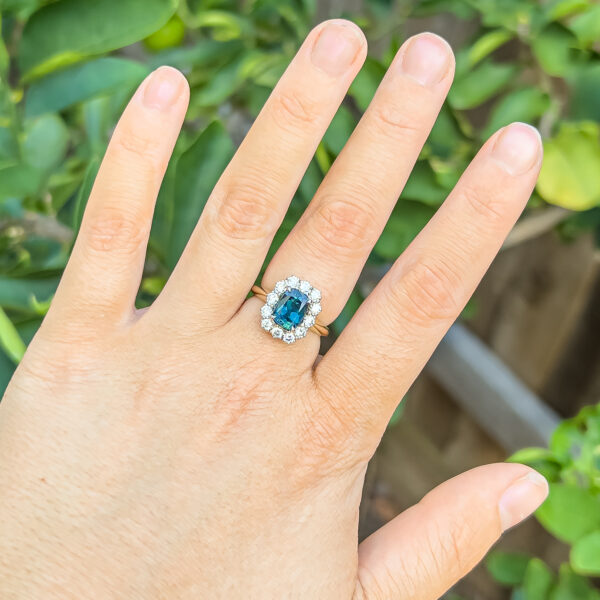 Australian Blue-Teal Parti Sapphire Ring with a Diamond Halo in Yellow and White Gold by World Treasure Designs