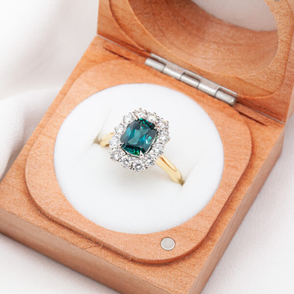 Australian Cushion Cut Blue-Teal Sapphire Ring with Halo of Diamonds in Yellow and White Gold by World Treasure Designs