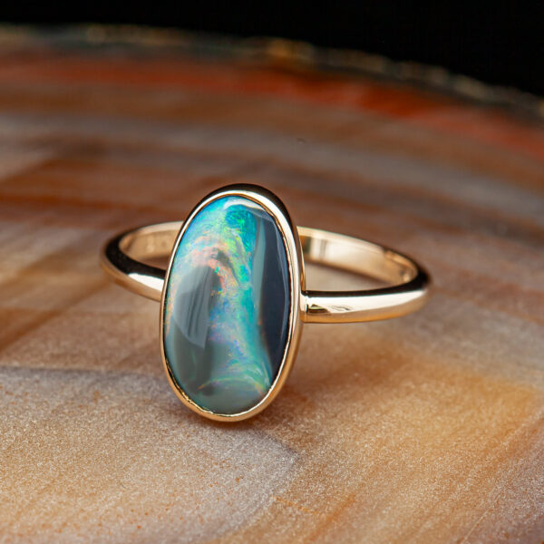 Bezel Set Australian Fossil Semi-Black Opal Ring in Yellow Gold by World Treasure Designs