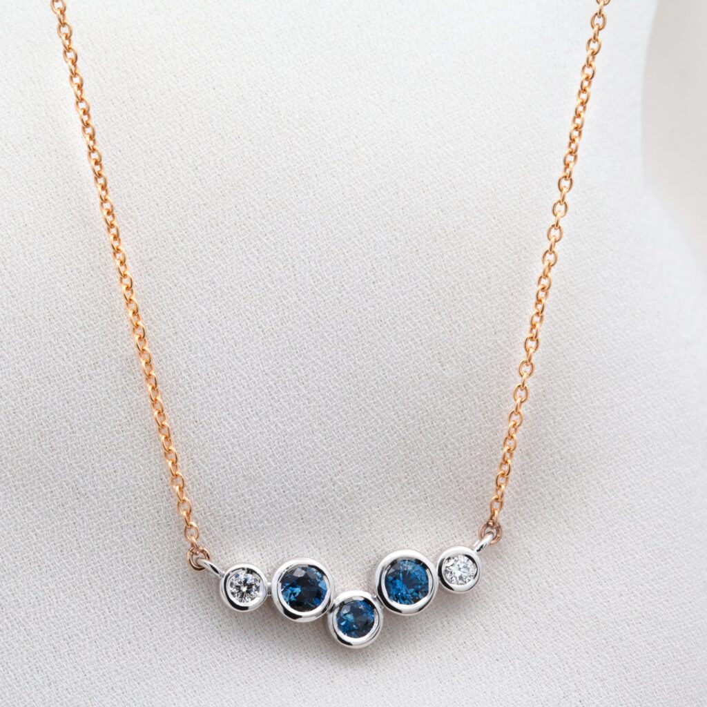 White And Yellow Gold Diamond And Blue Sapphire Bezel Set Pendant By World Treasure Designs