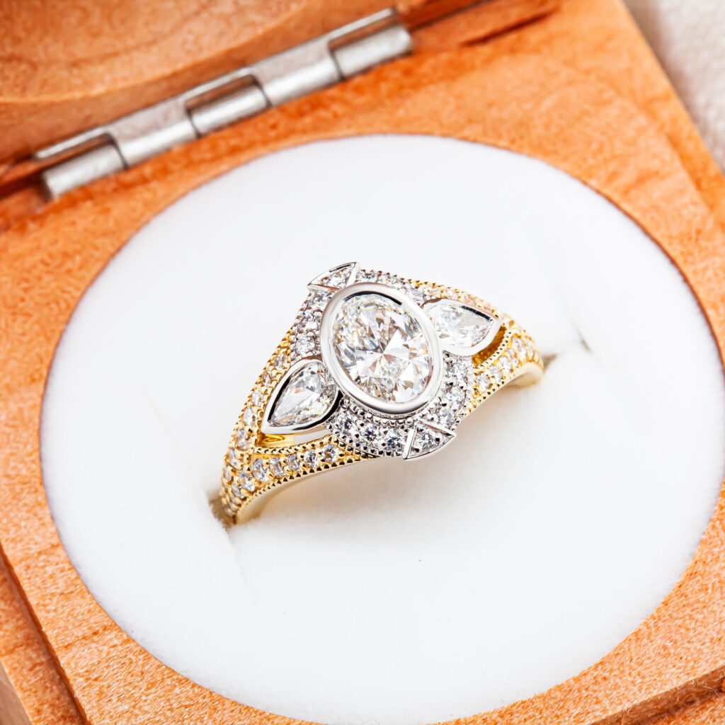 2-Tone Gold Engagement Ring With Oval, Round and Pear Diamonds By World Treasure Designs