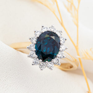 Australian Blue Sapphire Ring with a Halo of Diamonds in Yellow and White Gold by World Treasure Designs